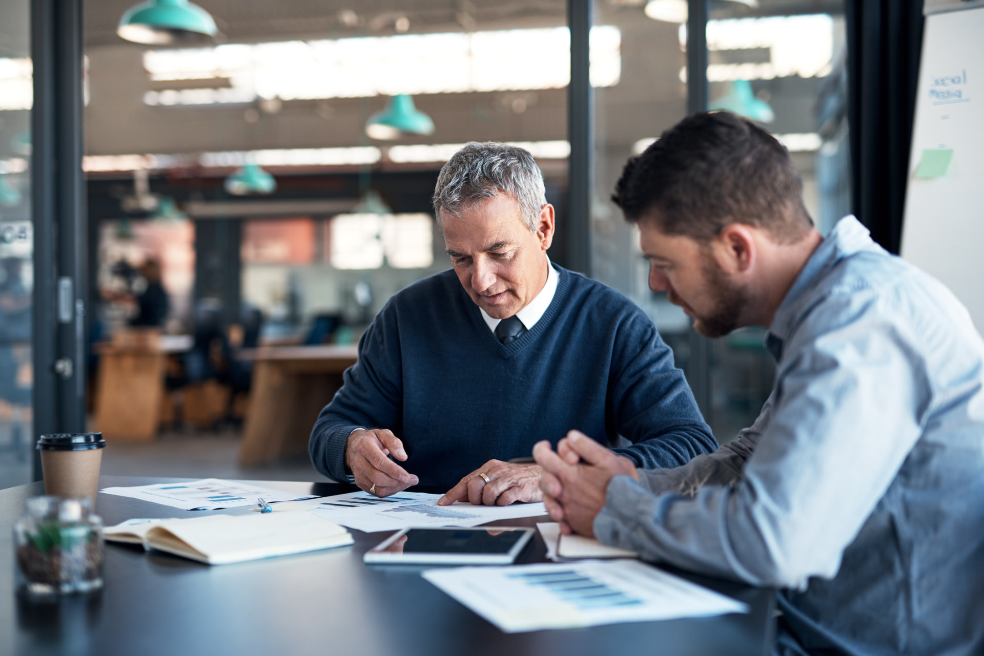 Two colleagues reviewing printed usage charts