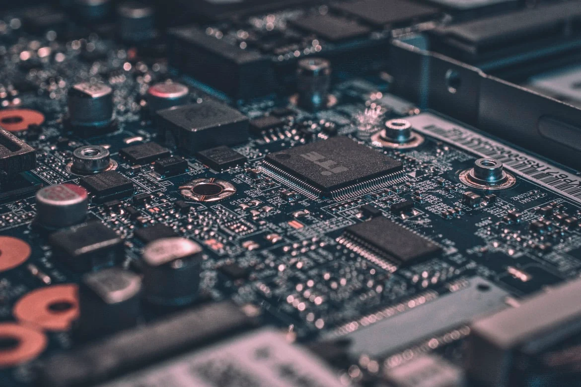 Close-up of a circuit board with a microchip, capacitors and soldered connections